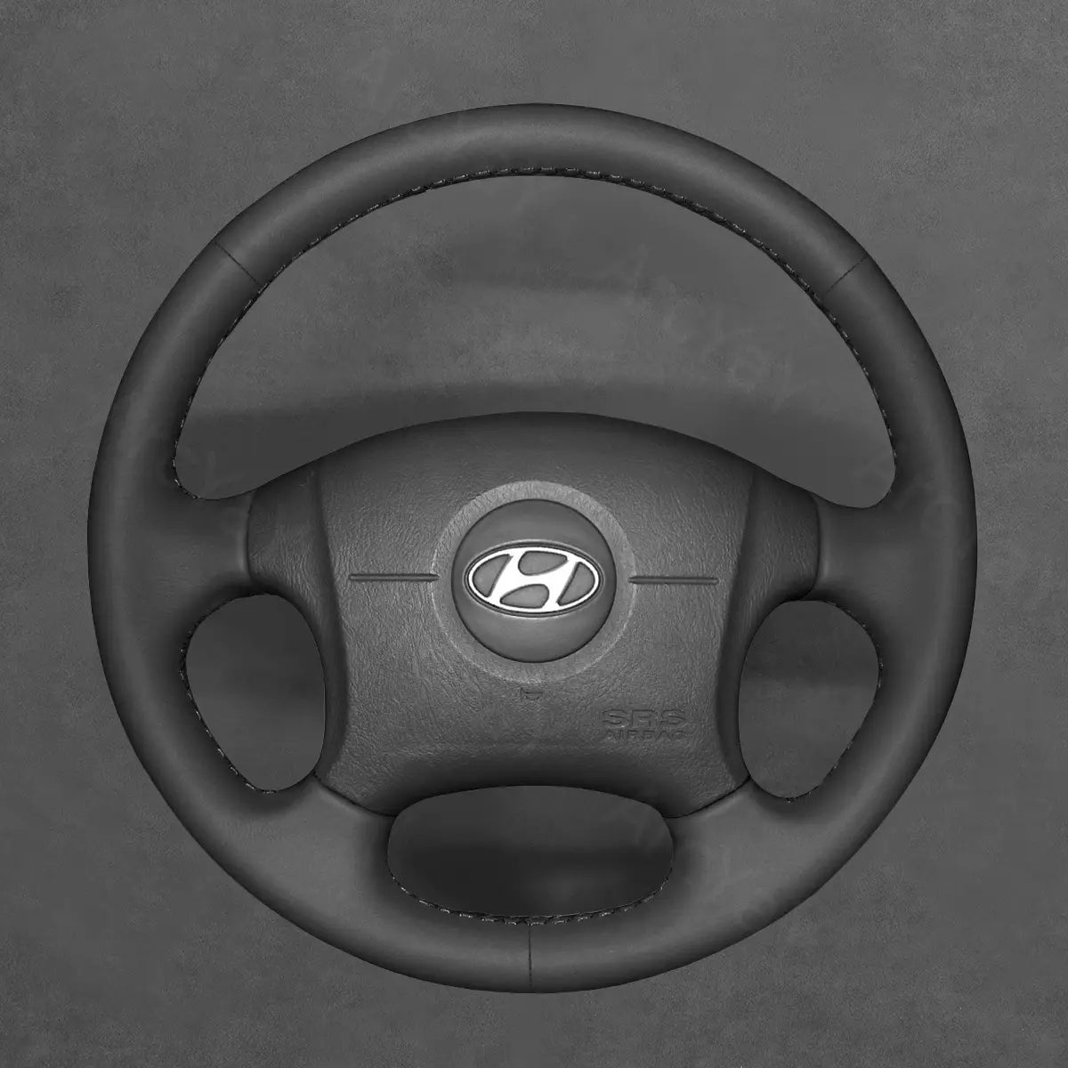 Get a custom-fit wheel cover for your Hyundai Elantra 2001-2006. Premium grip texture and durable stitching improve both comfort and aesthetics.