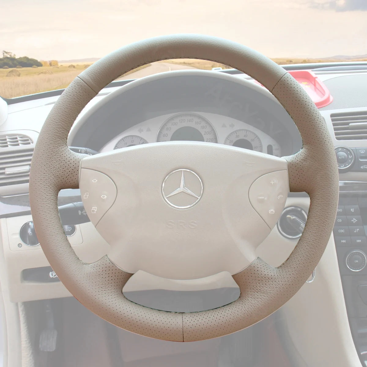 Custom-fit steering wheel cover for Mercedes Benz E-Class W211 (2003-2006). Enhances comfort and style for your car's interior.
